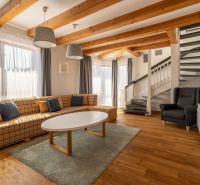 Living room in a 3-room apartment with a comfortable sofa and a wooden decor floor.