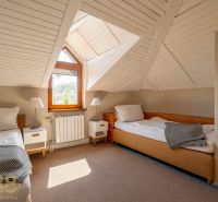 Attic room with two beds and a view in a 3-room apartment.