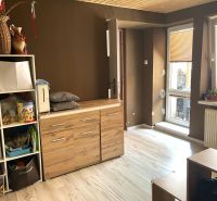 Interior of a family house with a shelving system and a wooden decor floor.