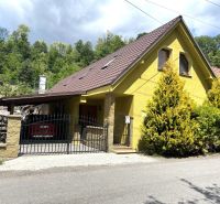 A family house in Bartošova Lehôtka with a yellow facade, a brown roof, and a front garden.