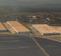 Aerial view of warehouses and halls in Galanta with the surrounding area of the village.