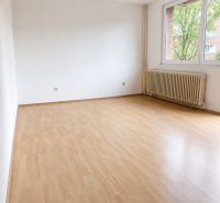 A spacious room in a 3-room apartment with a wood-decor floor and a large window.