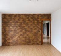 Interior of a 3-room apartment with a decorative wall and floor with a wooden decor.