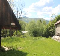 Žaškov, Matúšovská: Construction of houses surrounded by greenery, visible wooden and brick buildings.