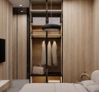 A wardrobe in a one-room apartment with a wood decor and open storage space.