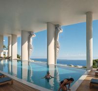 Luxury pool in Paje with ocean view and modern sculptures.