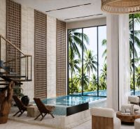 Interior of a 4-bedroom apartment with a pool, staircase, and view of palm trees in Paje.
