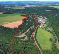 A view of agricultural and forest land in the Domaníky area with a landscape panorama.
