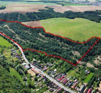 Aerial view of agricultural and forest lands in the village of Domaníky, outlined in red.