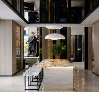 A stylish kitchen with an impressive island and a wooden decor floor in a 5-room apartment.