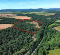 A forested area and agricultural land in Domaníky with a marked territory.