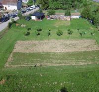 Land on Hlboká Street in Turany suitable for living, planted trees, and a garden.