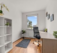 Office in a 4-room apartment with a desk, shelf, and floor with wooden decor.
