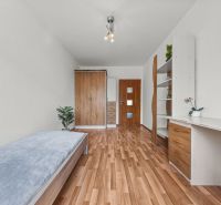 Bedroom in a 4-room apartment, bed, wardrobes, desk, floor with wooden decor.