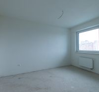 An empty room with white walls in a 2-room apartment, large window, radiator.