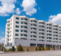 Apartment building on Rybničná Street in Bratislava - Vajnory with balconies and blue sky.