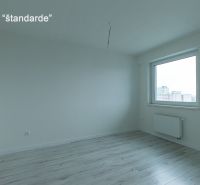 A room with a wooden floor decor, a window, and a radiator in a 2-room apartment.