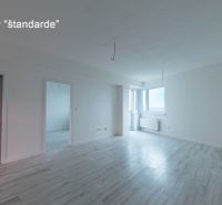 Living room with wood-patterned flooring in a standard two-room apartment.