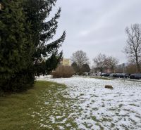 Snow-covered commercial lands in Zvolen with a view of the parking lot on Novozámocká.