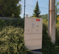 Electrical cabinet next to a pole and vegetation in Lietavská Svinná-Babkov, Residential plots.