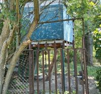 A wooden treehouse surrounded by greenery in Nové Zámky on the street.