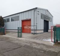 Warehouses and halls in the district of KE - Džungľa, with a metal structure and a red gate.