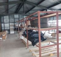 Warehouses and halls with metal shelves and stored items on the floor.