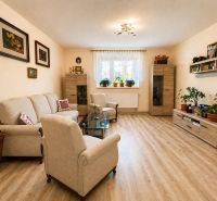 Living room in a family house with comfortable sofas and a wooden decor floor.