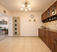 A kitchen with brown cabinets and ceramic flooring, Family house.