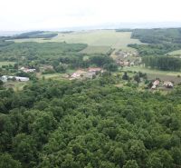 Aerial view of agricultural and forest lands around Trebušovce with village settlements.