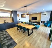 Living room in a family house with a wooden decor floor and modern furniture.