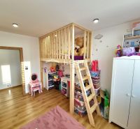 Children's room in a family house with a wooden decor floor and a bunk bed.