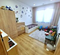 Children's room in a family house with a wooden decor floor, decorations, and toys.