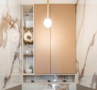 Marble cladding with decorations in the bathroom of a 3-room apartment.