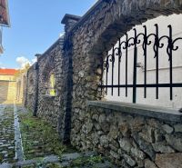 Stone wall and iron bars on Dolná Street in Banská Bystrica.