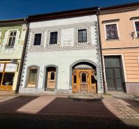 Dolná Street in Banská Bystrica features historic buildings with shops and a bar.
