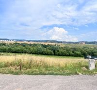 A landscape with a meadow and trees, a view from a residential building in Krupina.
