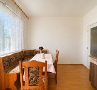 Dining area with a corner bench, table, chair, and floor with a wooden decor.