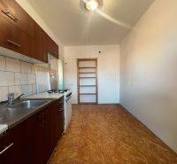A kitchen in a 2-room apartment with a kitchen unit and a floor with a wooden decor.