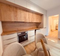 A kitchen in a 3-room apartment with a wood-decor floor and a built-in unit.
