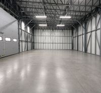 Empty manufacturing spaces with steel structure and concrete floor.