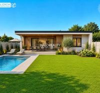A pool and a terrace with loungers in the garden of the property in Juri nad Hronom.