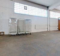 Warehouses and halls with empty space, sliding trolleys, and a glass partition.