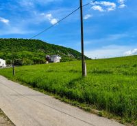 Hilly landscape near Fintice with residential plots and countryside in the background.