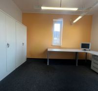 Office with furniture, computer, and cabinets on a light floor.