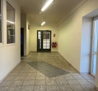 A corridor in production areas with ceramic tiles and double doors.