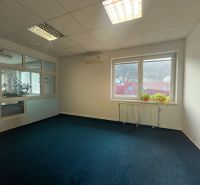 Office with a blue carpet and a window, manufacturing facilities.