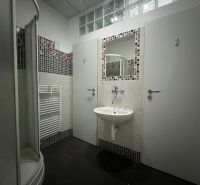 Bathroom with a sink, shower, mirror, and door in warehouses and halls.