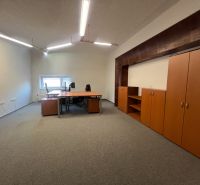 Interior with a table and cabinets in warehouse and hall spaces.
