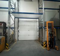 Warehouses and halls with shelves, a forklift, and a closed garage door.